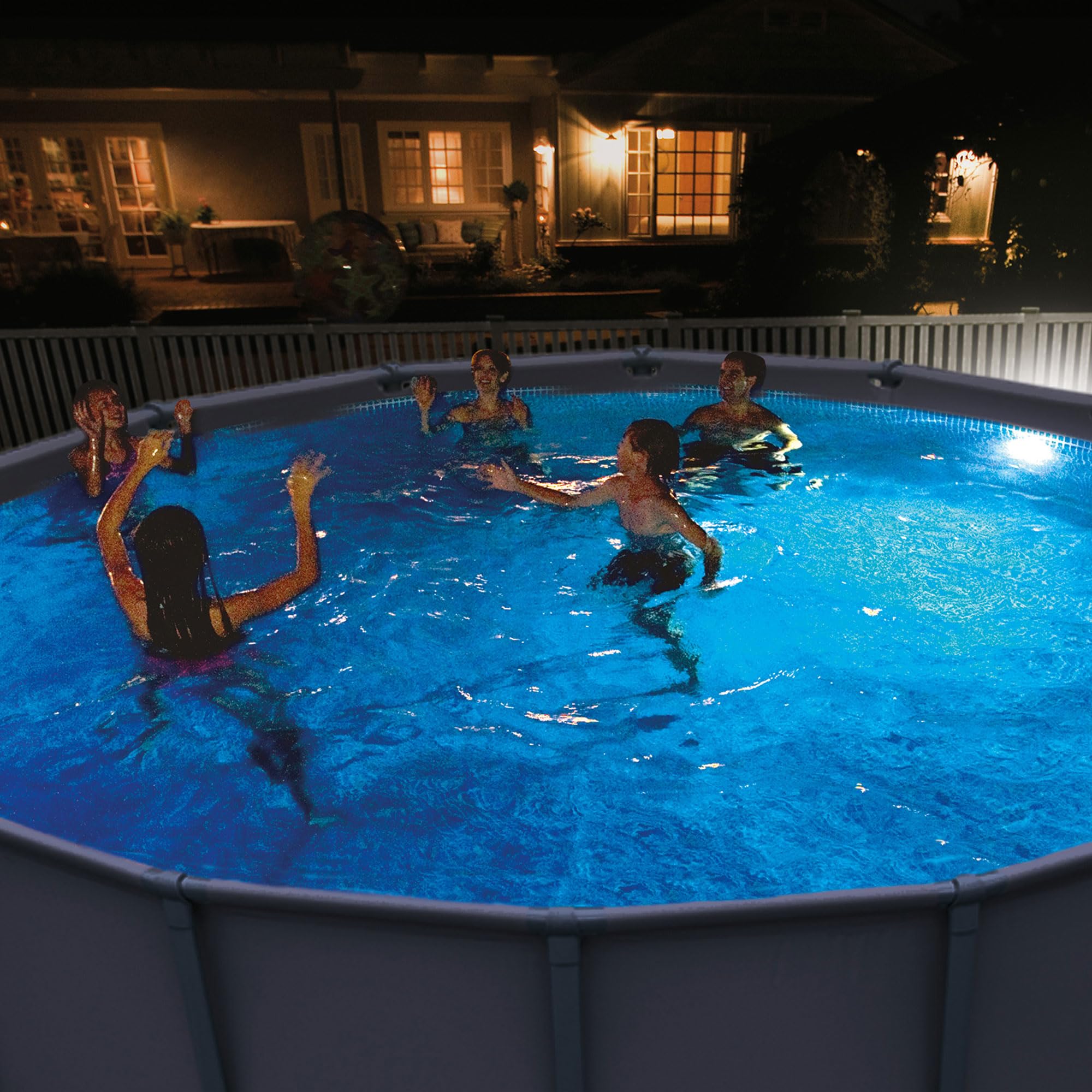 Night lifestyle photo of swimmers in an above-ground pool illuminated blue by the Intex underwater LED light