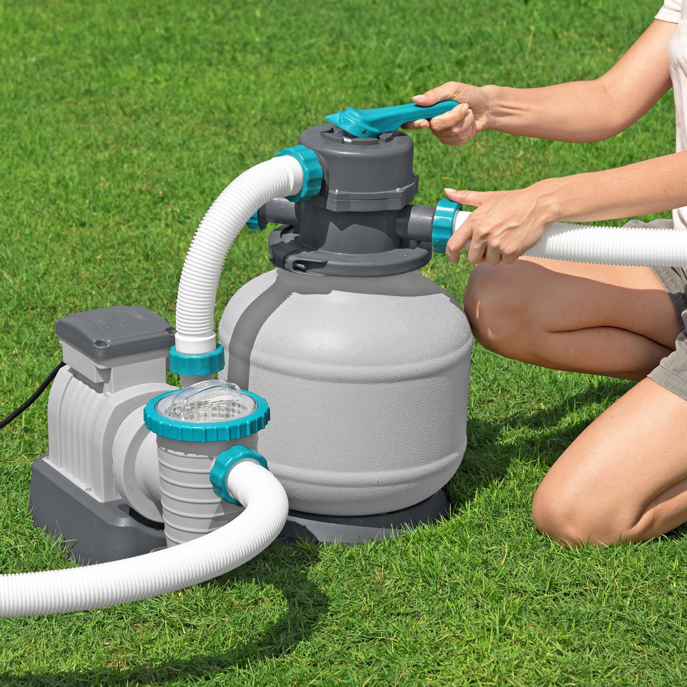 Bestway sand filter pump set up on grass beside an above-ground pool